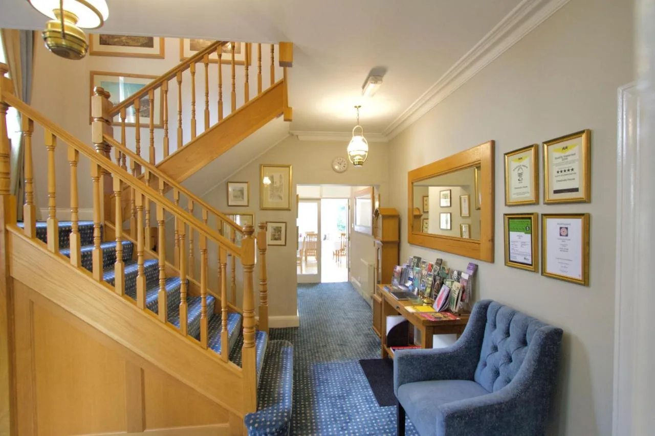 a hallway with two chairs and a staircase at Chestnuts House Boutique B&B in Bath